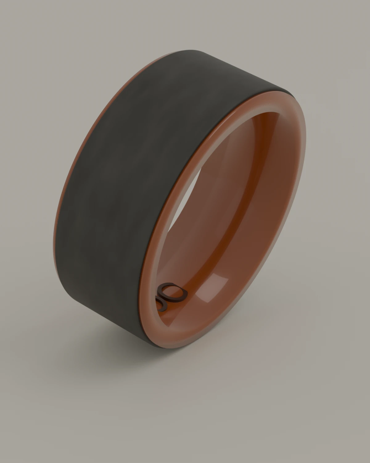 A wide band ring standing on a pale ground. The outside is flat grey; the inside is glazed a deep amber and carries one word on the inside, at the lower edge.